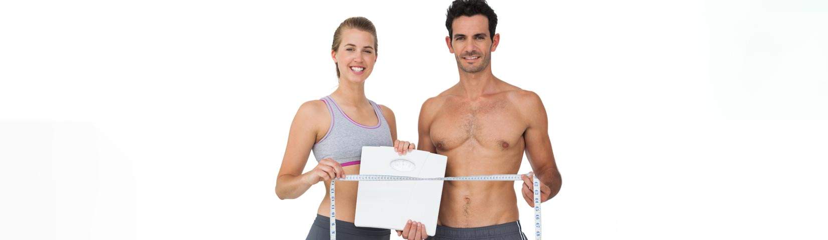 sporty couple holding scales measuring tapee