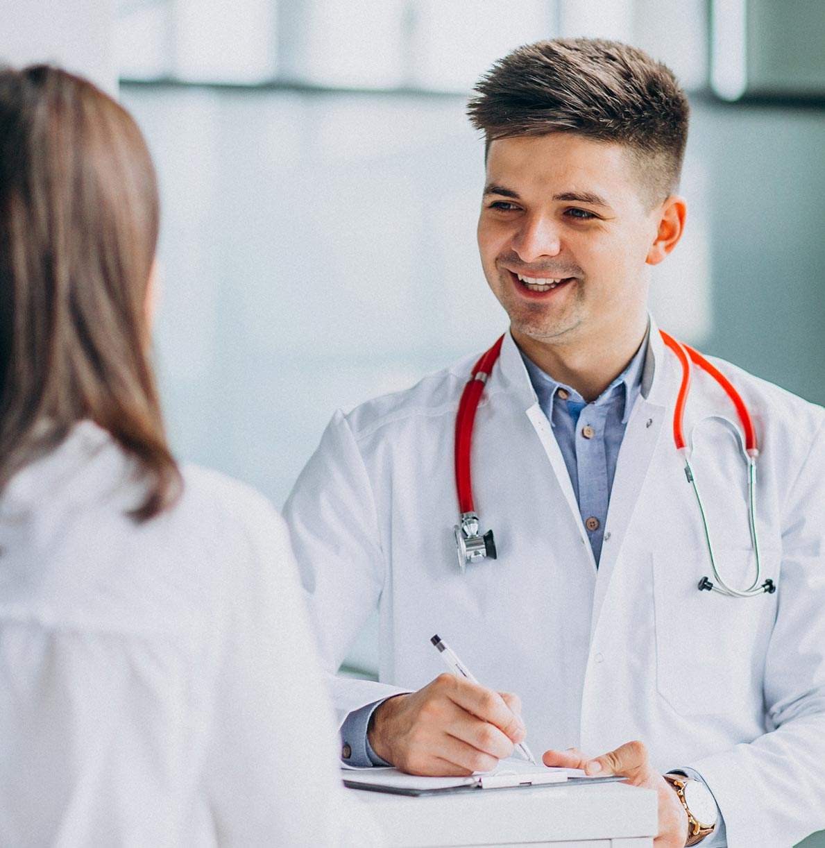 young male psysician with patient hospitall